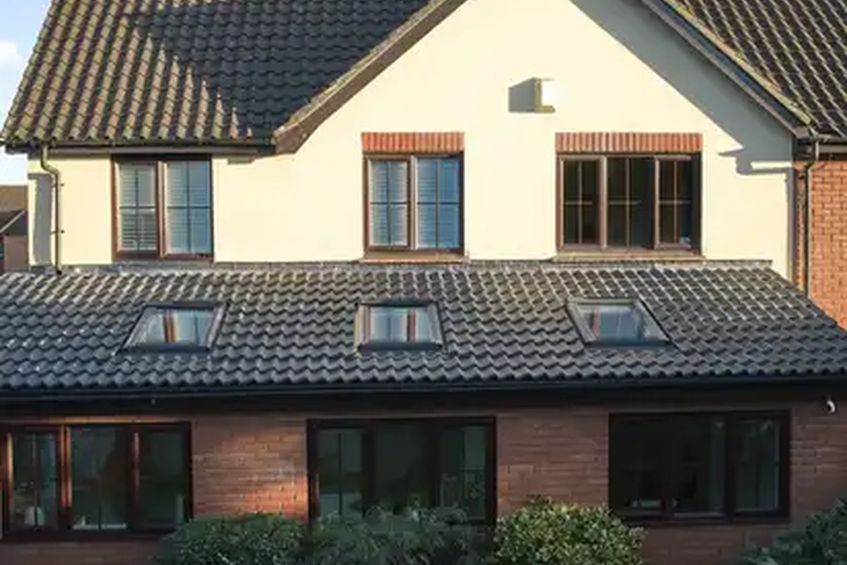 Professional roofer working on a UK roof